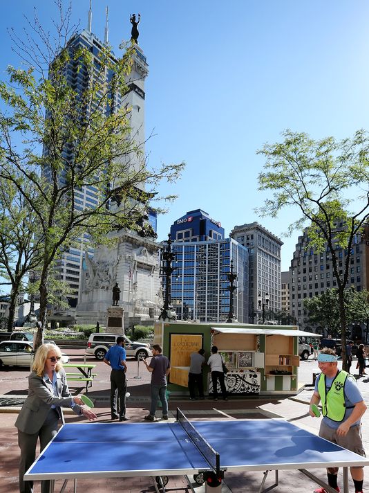 In front of the Emmis headquarters, late summer passersby enjoy interactivities as part of Spark Monument Circle.