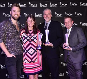 Charles Kelly from Lady Antebellum presenting the CMA Award to Lisa Wall, Dave O'brien and Fritz Moser 