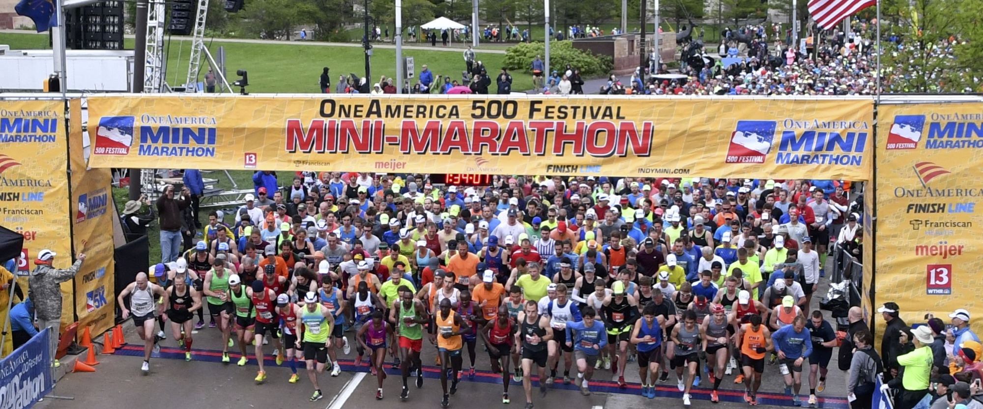 Runners cross the starting line at the One America 500 Festival Mini-Marathon which kicks off the Month of May.
