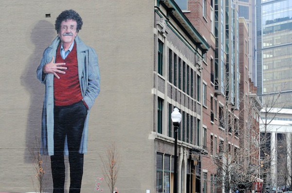 Veteran and famous Hoosier author Kurt Vonnegut, depicted in this mural on a building along Mass Ave in Indy, advocated for remembering November 11 as a way to avoid war.